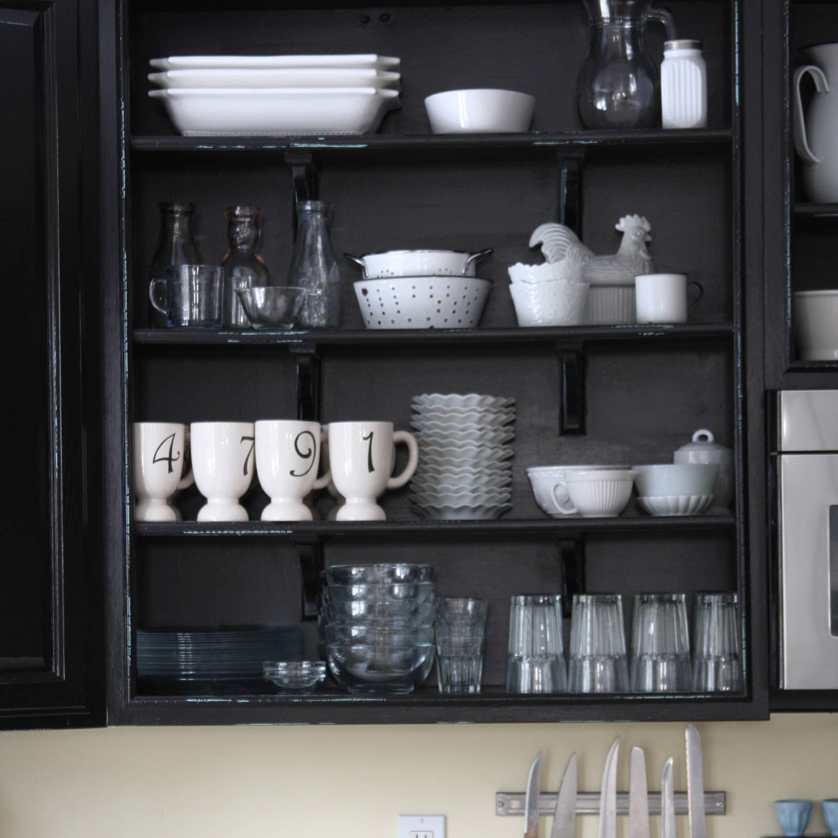 Black cabinet with black backs and dishes